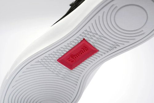 Savalé sneaker sole detail with the red logo tab