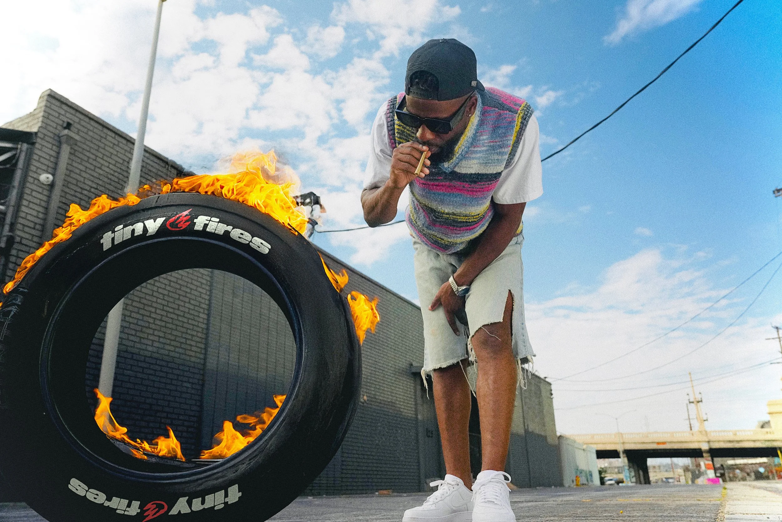 Editorial cannabis lifestyle photography in California with smoking subject and flaming tire