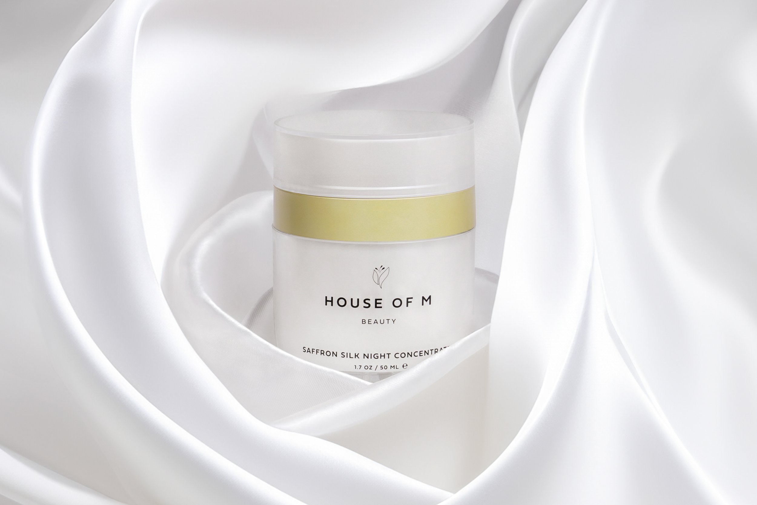 Premium skincare product photo, luxury night cream jar styled in silky fabric studio lighting