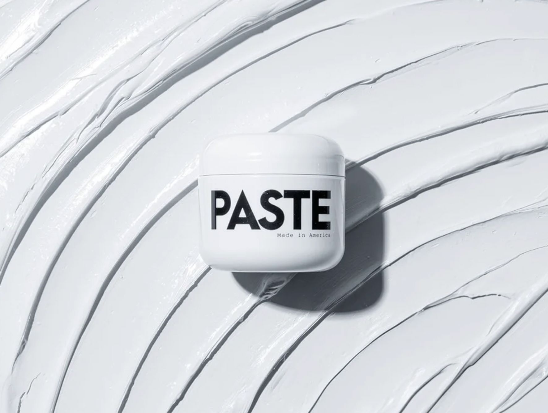 Paste hair styling cream texture macro shot on white — men's grooming product photographer Los Angeles