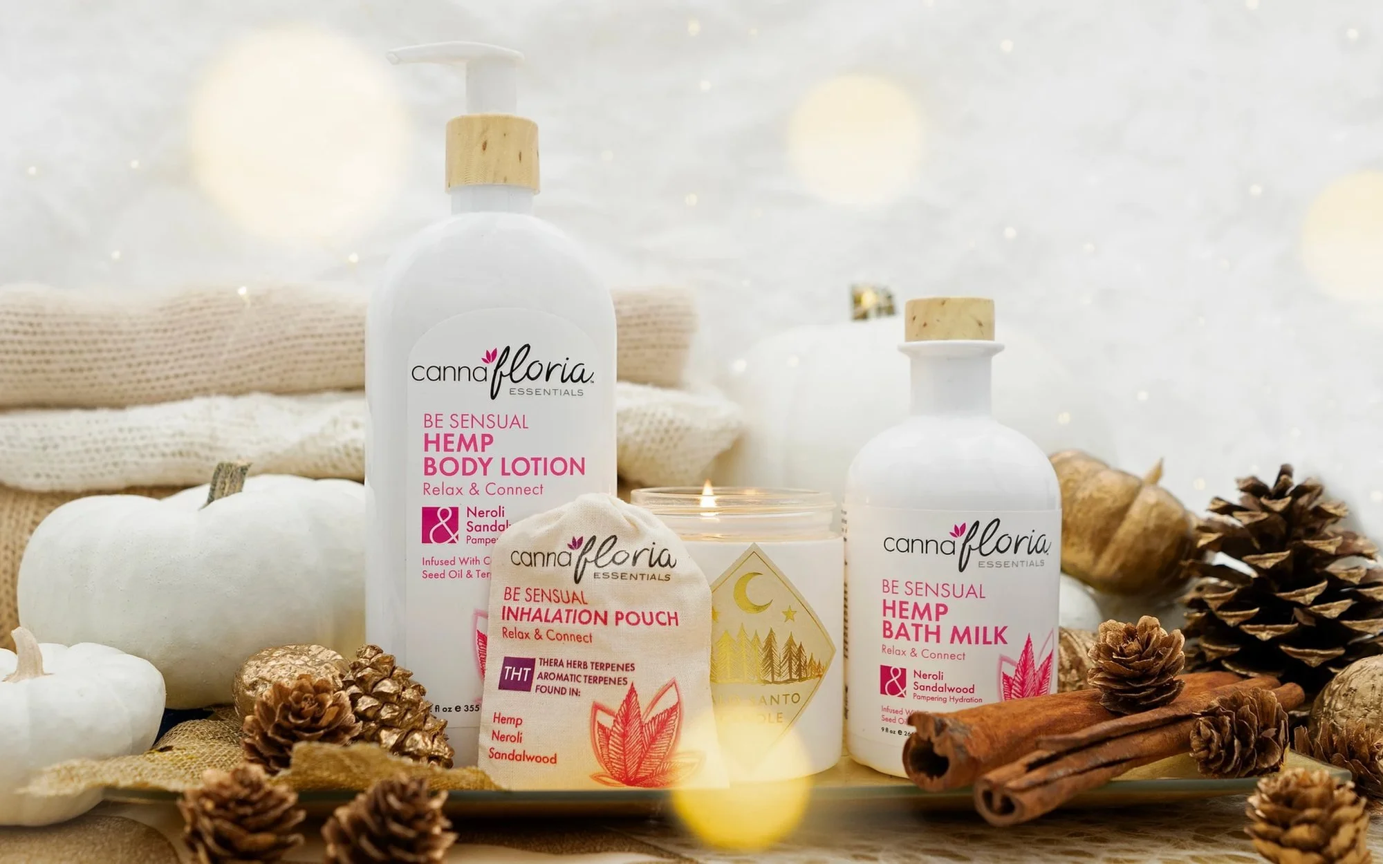 Holiday body lotion, bath milk and gift box styled with pinecones and candles, holiday product photography