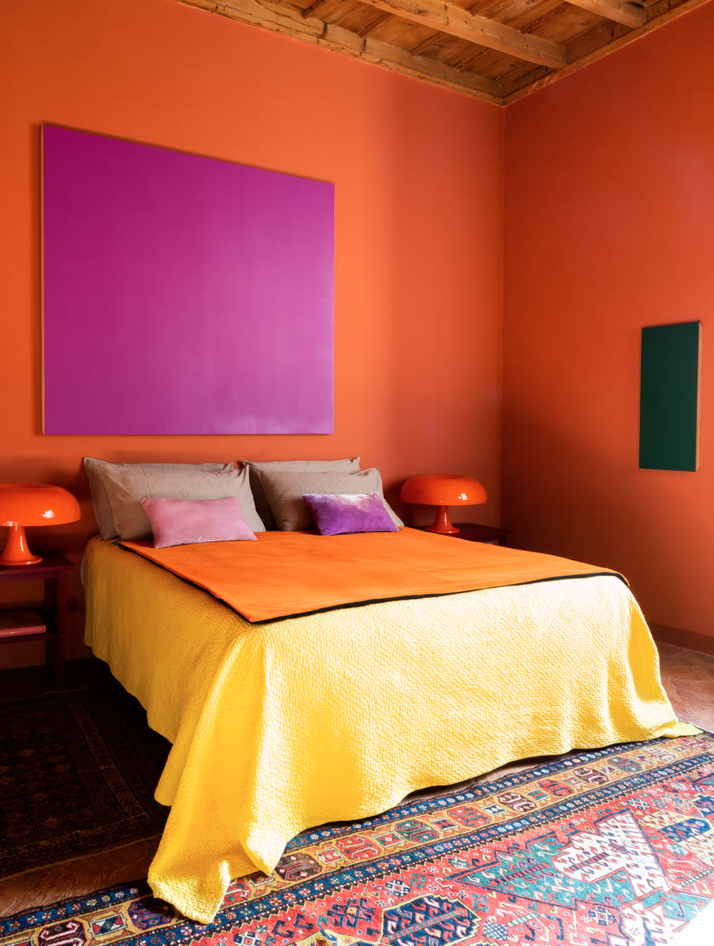 ‘The colours call out to us’: bright orange bedroom with a pair of Gae Aulenti lights. Photograph: Monica Spezia/Spezia