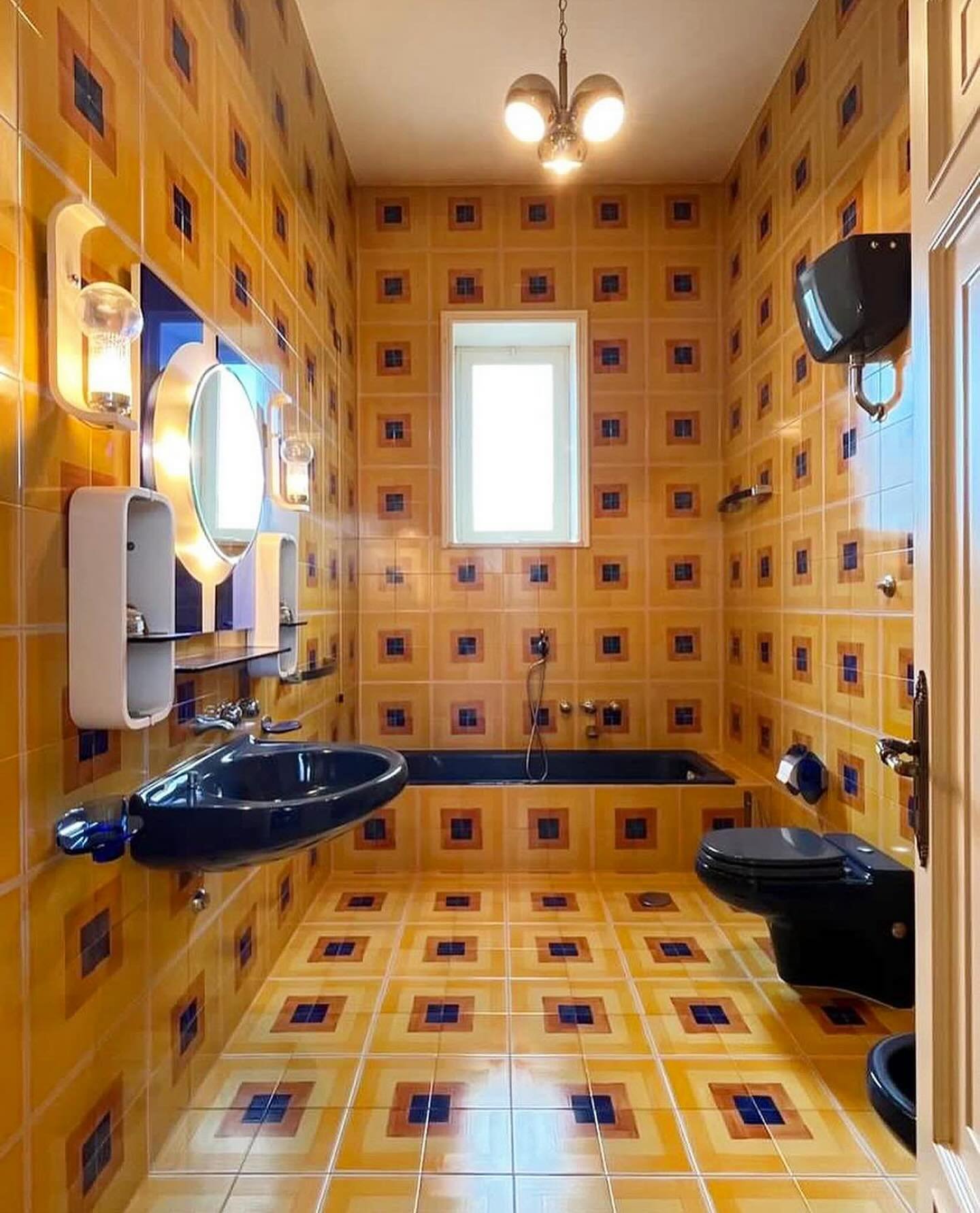 1970s tile-clad bathroom in the home of @whereiseugenio located in Southern Italy