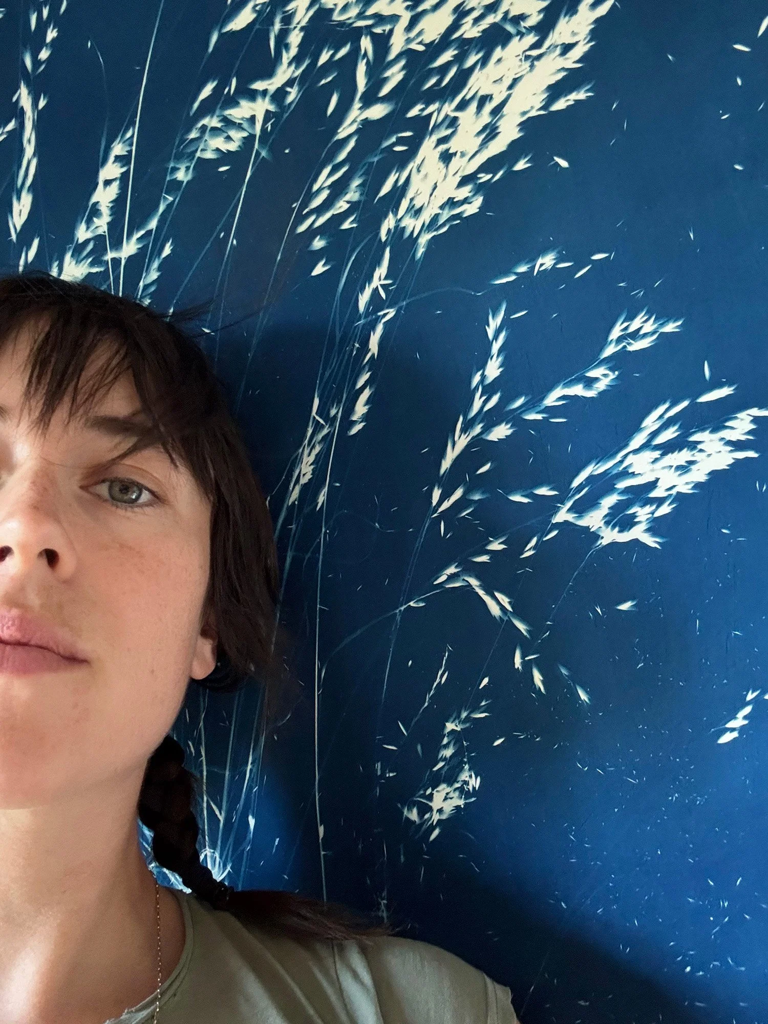 Jade Donaldson standing in front of a cyanotype