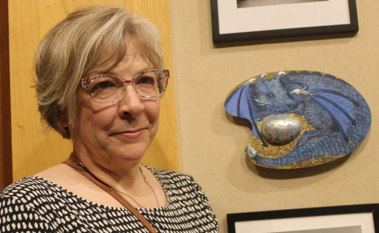 Lynn Litchfield standing in front of her piece entitled "Blue Dragon"