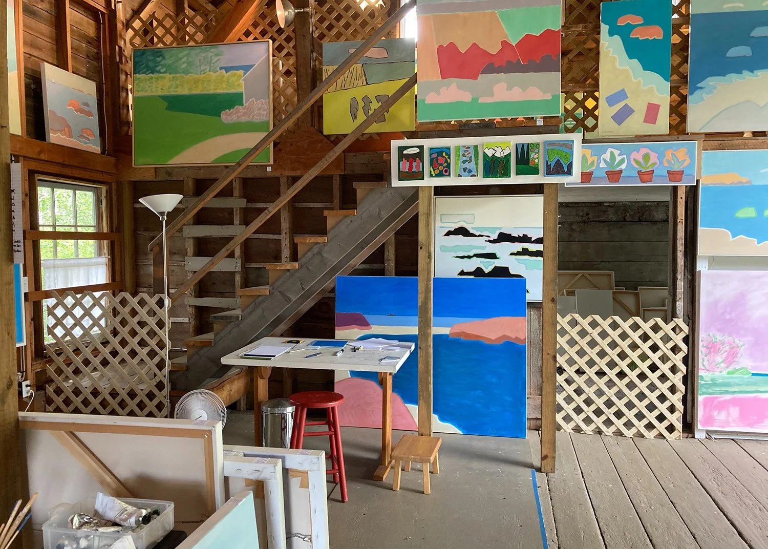 Interior of Heidi Baxter's studio, a bright and spacious multi-level space full of paintings