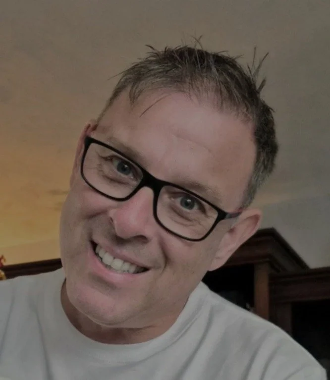 Ron Costa, smiling man wearing glasses