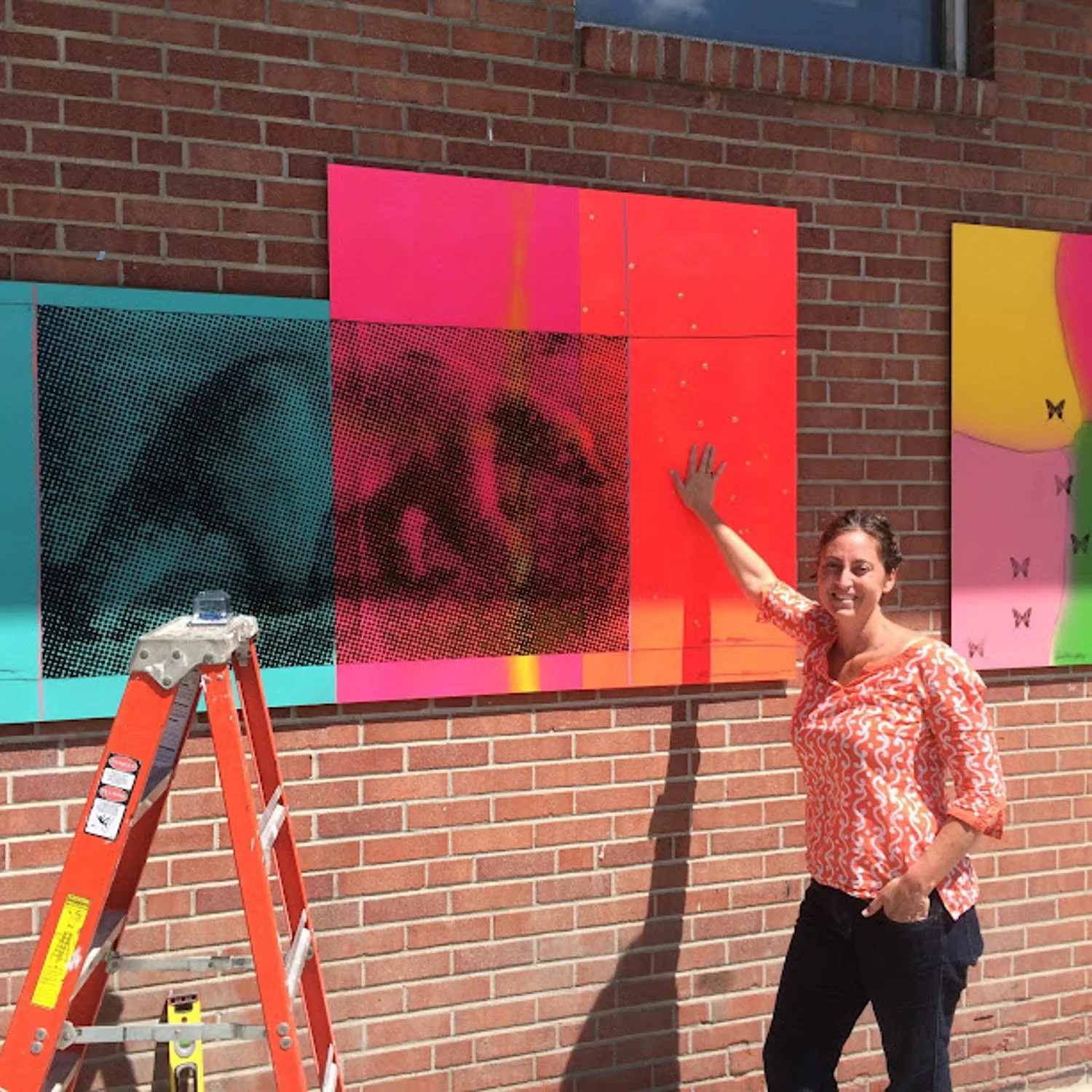 Kadie Salfi installing an exterior art piece