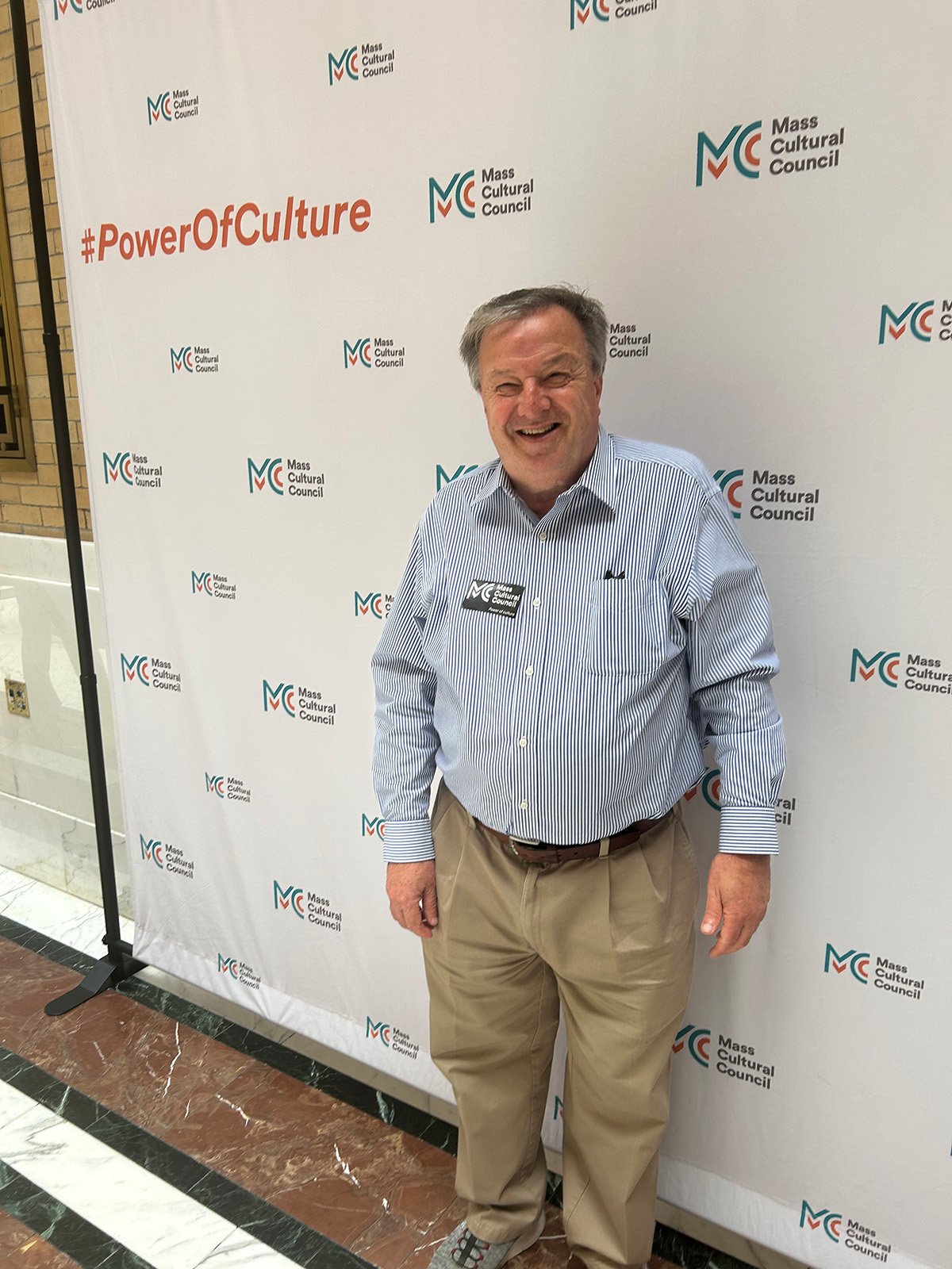 David Poyant in front of an MCC banner