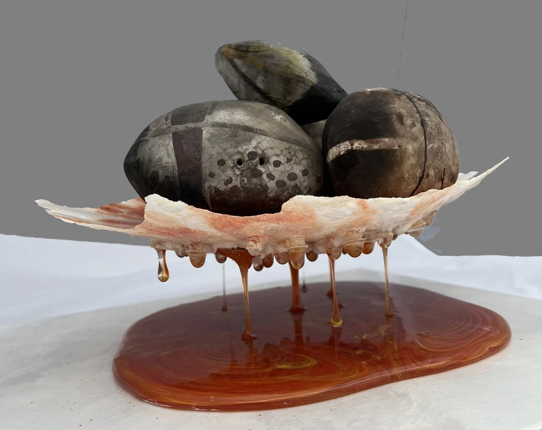  Lauren Quinn   
 Hot Lava Float   
12" x 9" x  7.5" 
Pit fired clay and fused glass Hot Lava Float embraces my love of fire. The clay briquettes were pit fired 20" under the ground with many combustibles  such as wood chips, seaweed, salt, eggshells