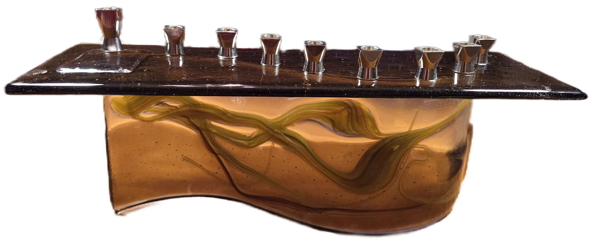  Melynda Schudrich   
 Gathered Radiance   
14" x 4" 
Fused glass This fused glass menorah incorporates pulled vitrigraph glass arranged in flowing forms that echo the flames of the candles traditionally lit during Hanukkah. Each line of glass sugges