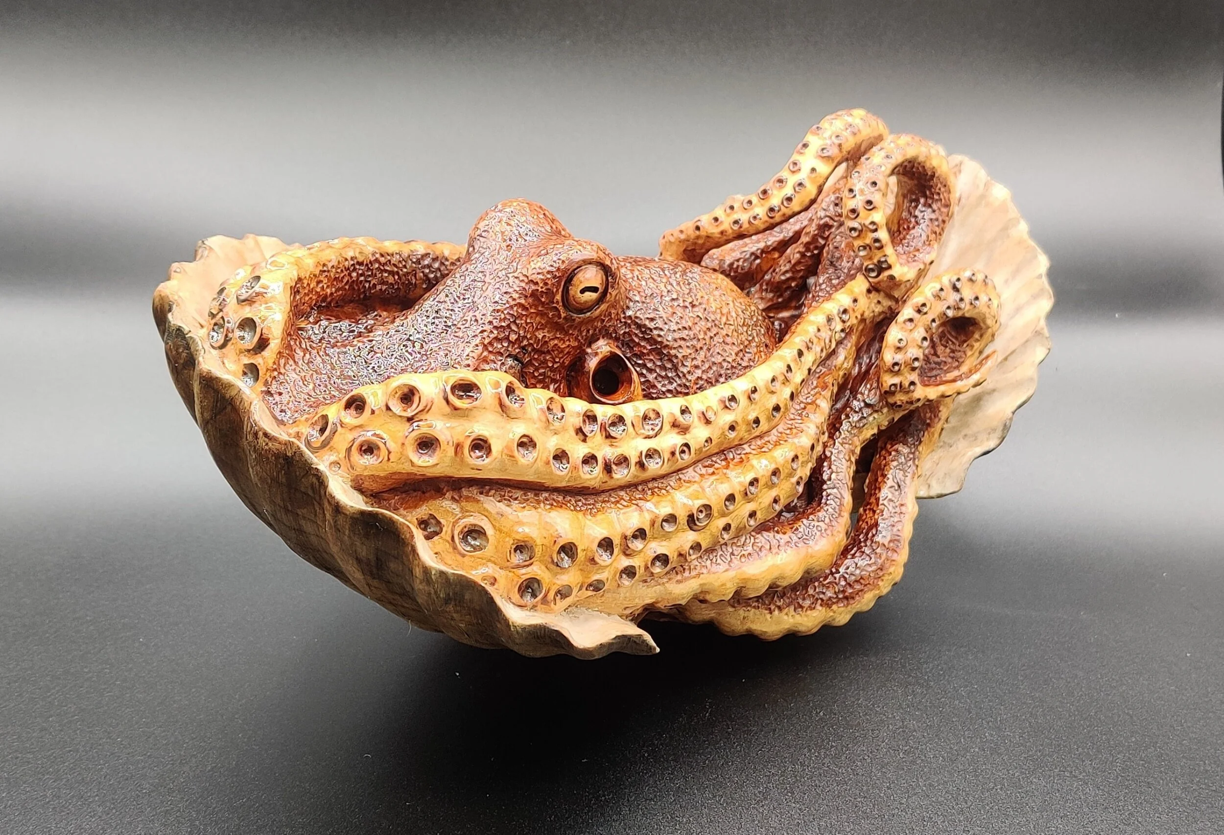 Octopus finding refuge in scallop shell - one piece oak - £1400