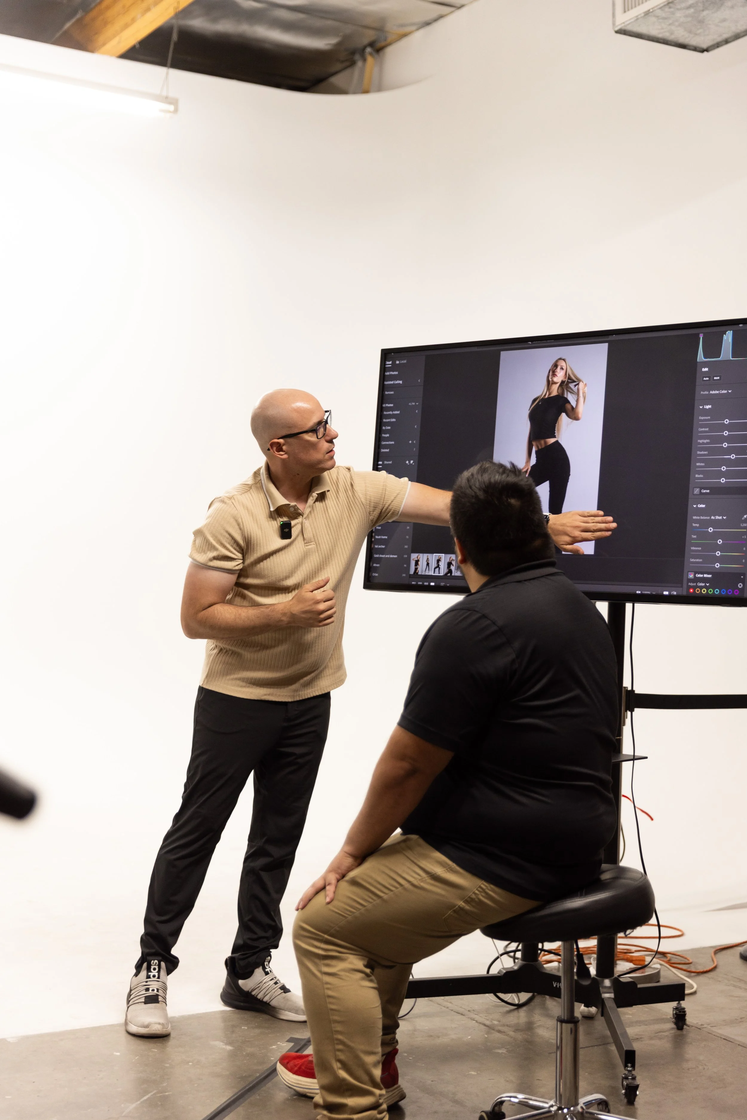 James Patrick teaching and giving real-time feedback to a photographer during Cover Sessions at The Hive Studios in Phoenix, guiding lighting, composition, and editorial decision-making in a live studio environment.