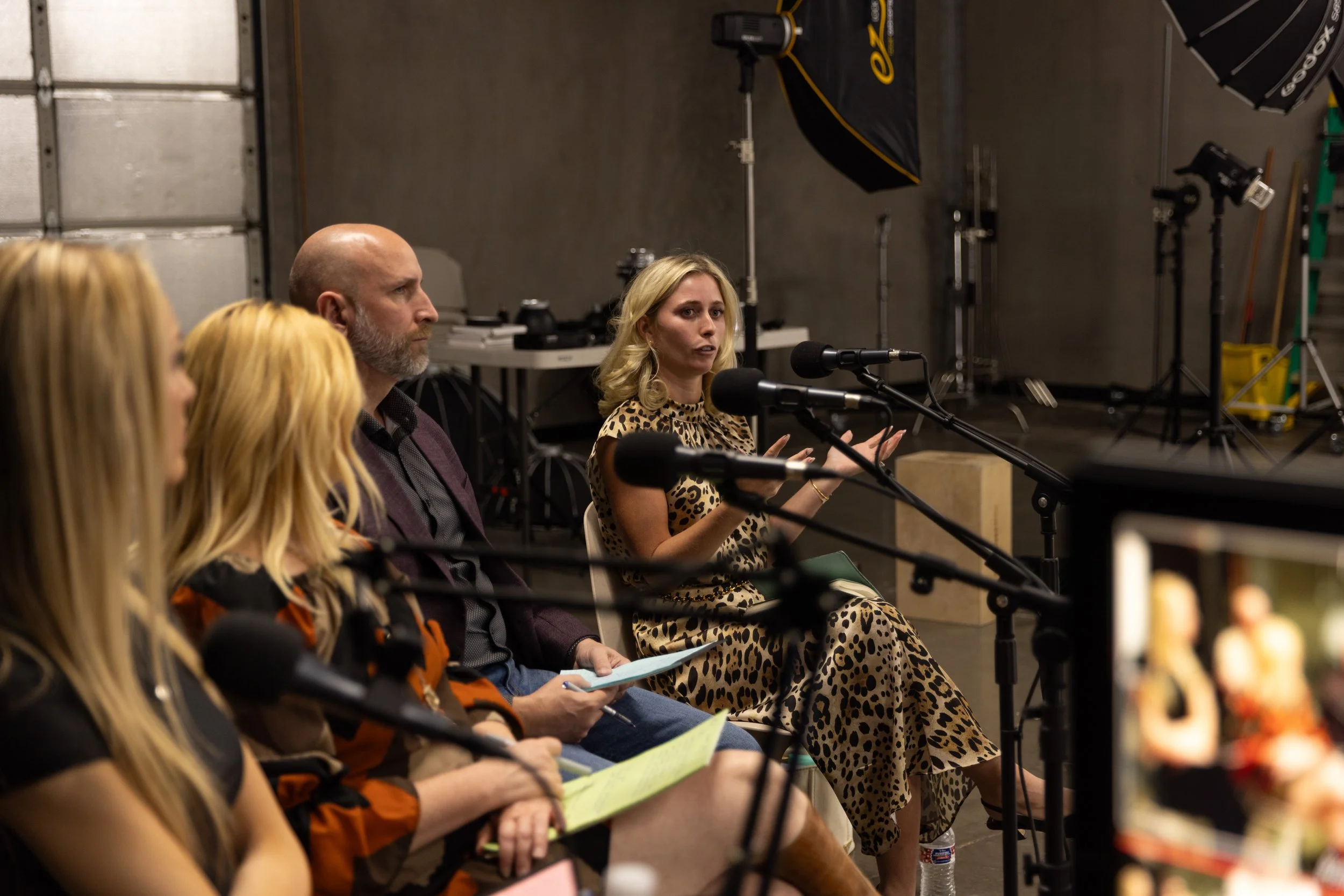 Panel of industry professionals at Cover Sessions inside The Hive Studios in Phoenix, observing and giving live feedback to photographers during an editorial photography workshop.