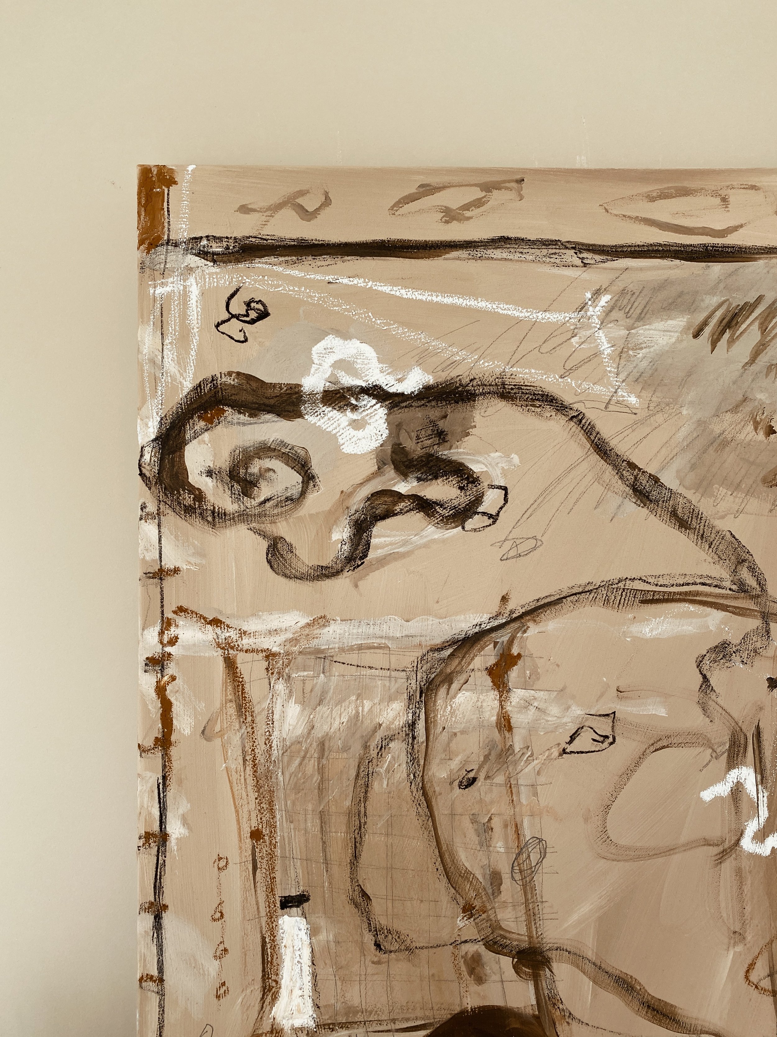 Close-up of an abstract painting with black, white, and brown brushstrokes on a beige canvas.