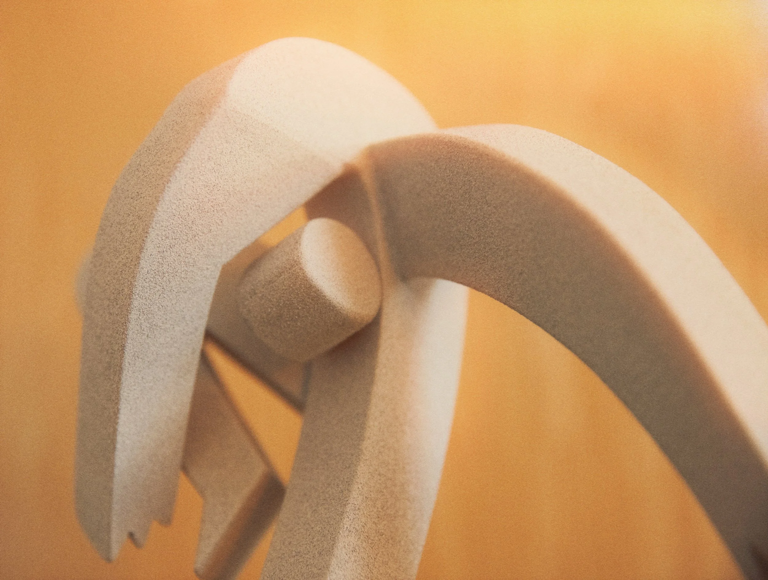 Close-up of curly white paper clips on a brown background.