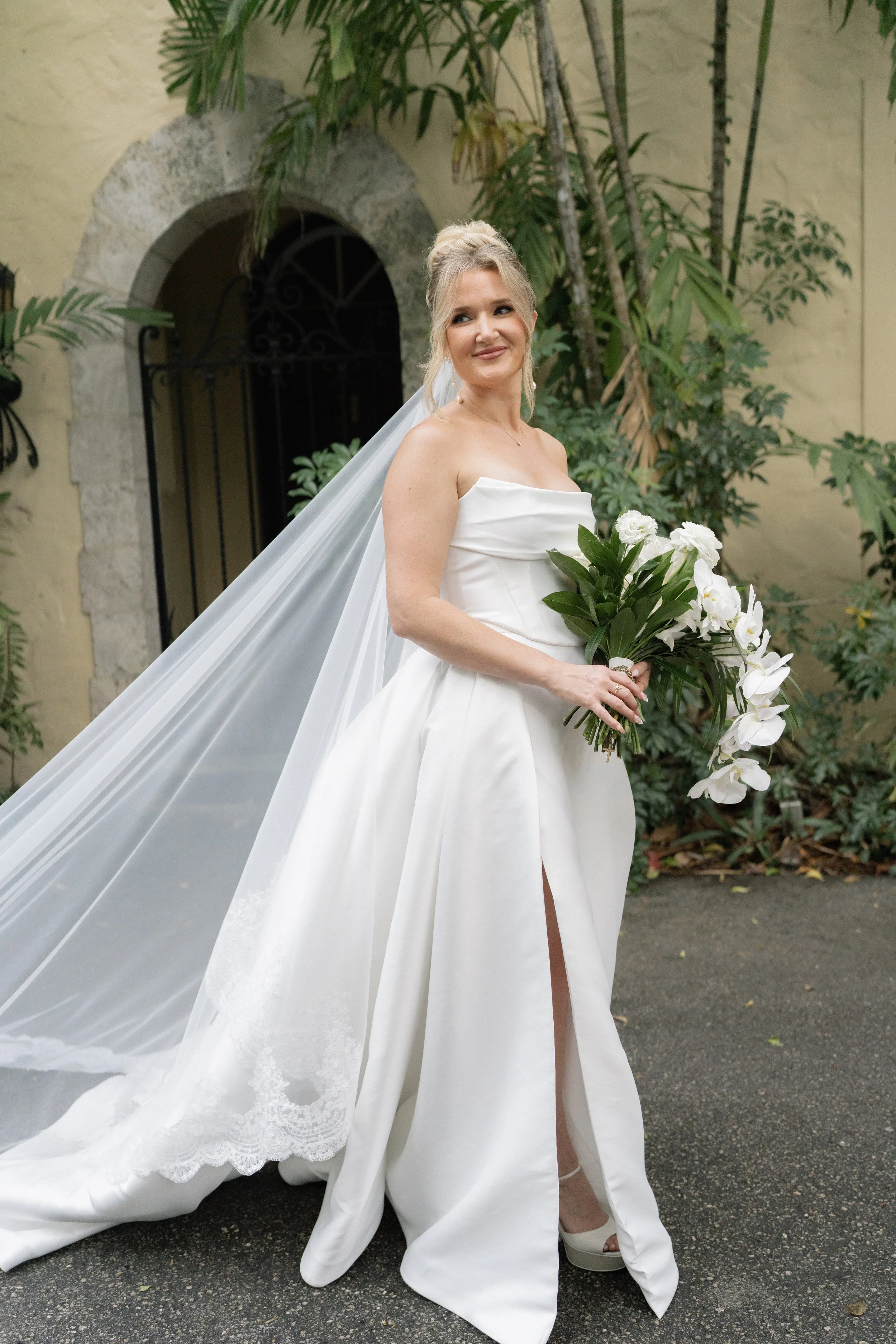 BLONDE WOMAN WEARING PROFESSIONAL BRIDAL HAIR AND MAKEUP FOR HER WEDDING DAY AT VILLA WOODVINE IN MIAMI FLORIDA