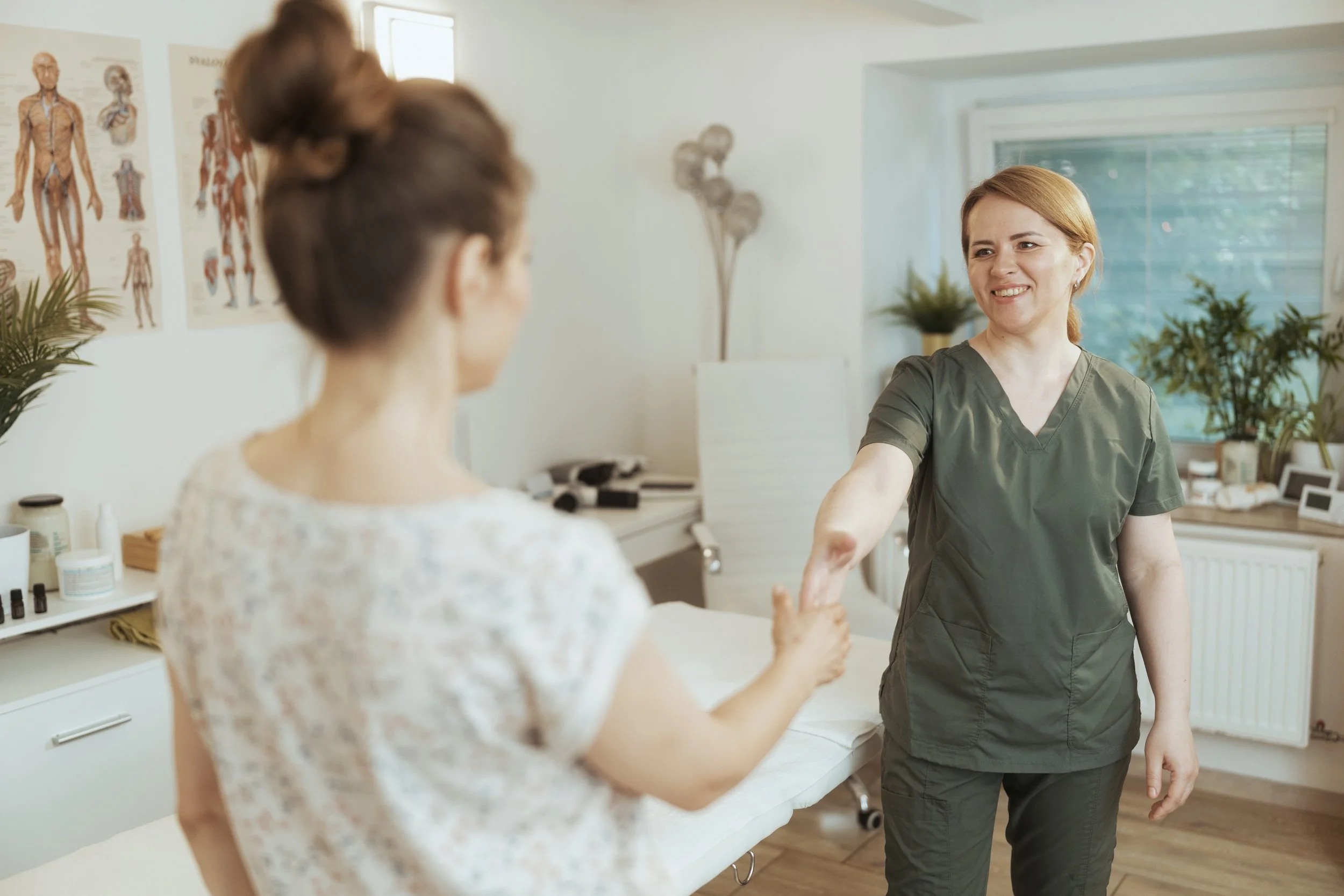Patient shaking hands with craniosacral therapist