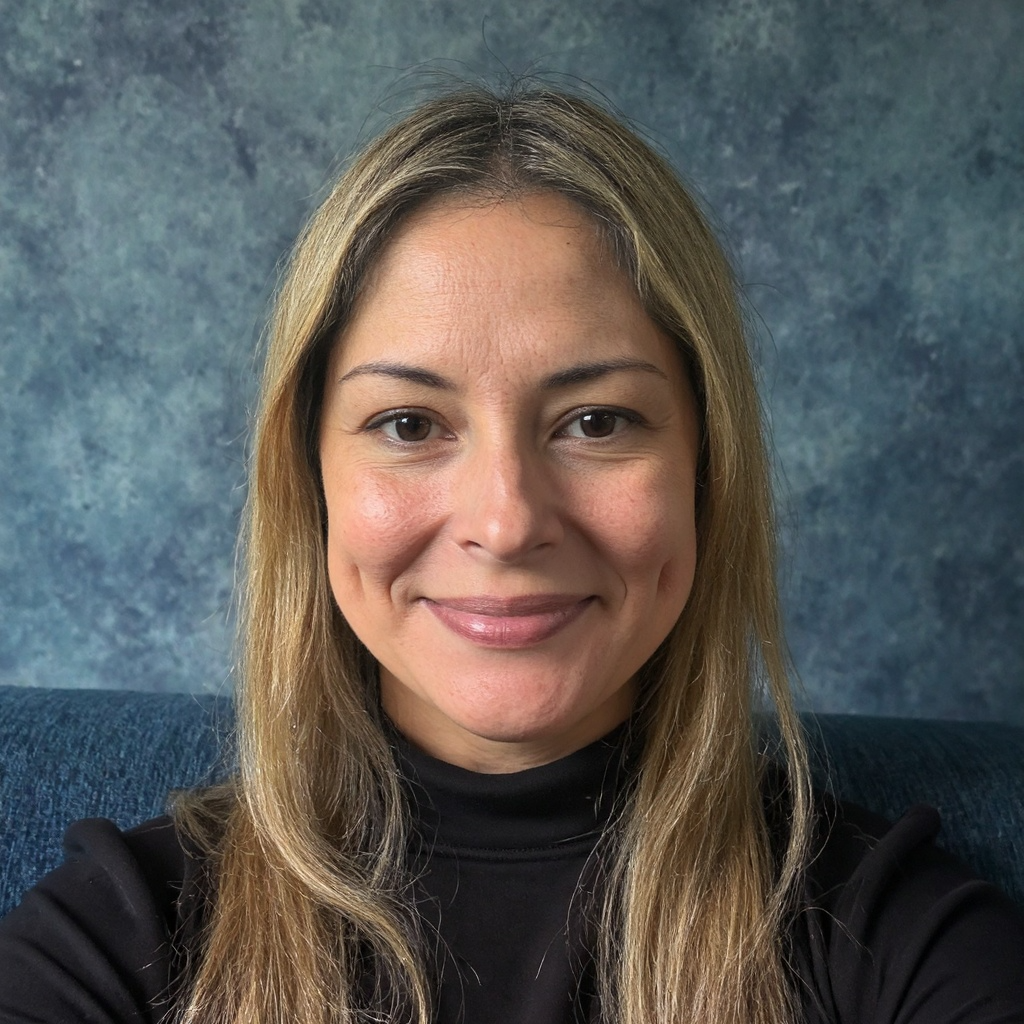 middle aged woman in a black turtleneck with long blonde hair