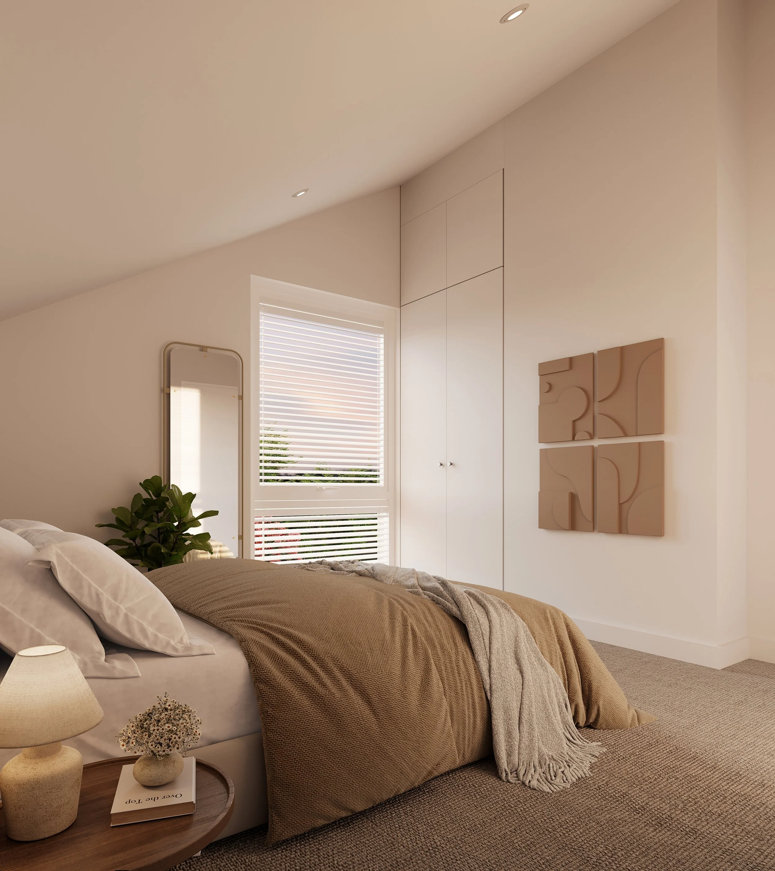 A bedroom with a neatly made bed, beige bedding, and a throw blanket. There is a side table with a lamp, a flower arrangement, and a book. A tall mirror, a window with blinds, and modern wall art are visible.