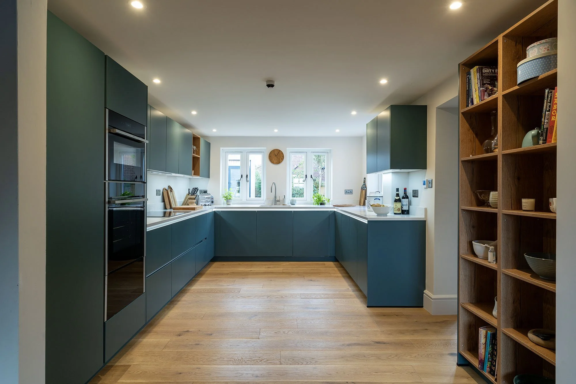 blue handleless kitchen with white worktops