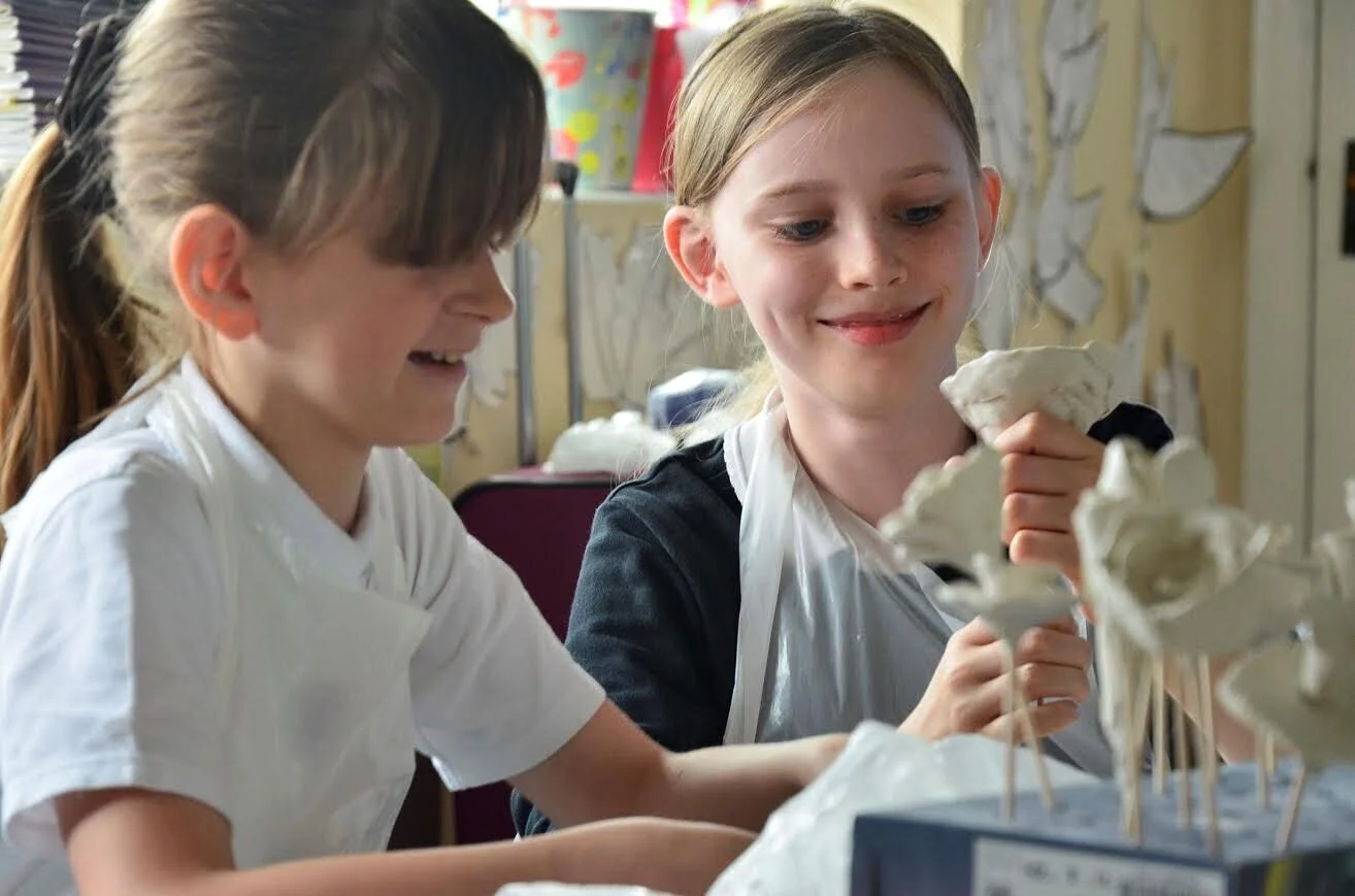 Ridgeway Primary School children working on creating flowers. Later glazed in yellow.