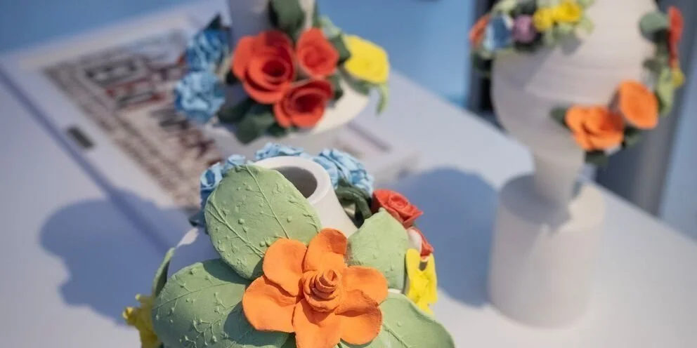 Image of three white ceramic trophies adorned with flowers. Image: Greater London Authority/Caroline Teo 