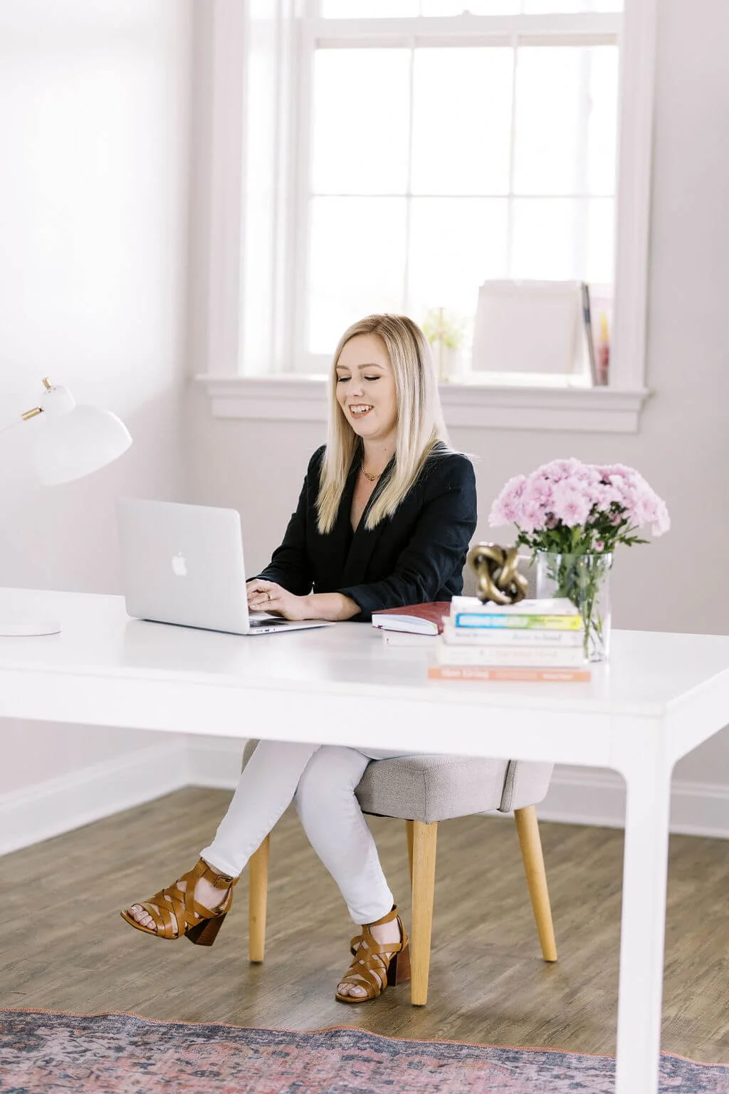 Dr. Jenny White sits at her desk and is now accepting some insurance plans. Please keep reading to find out how to apply insurance benefits to your therapy sessions with Dr. Jenny for anxiety, workplace stress, and relationship issues.