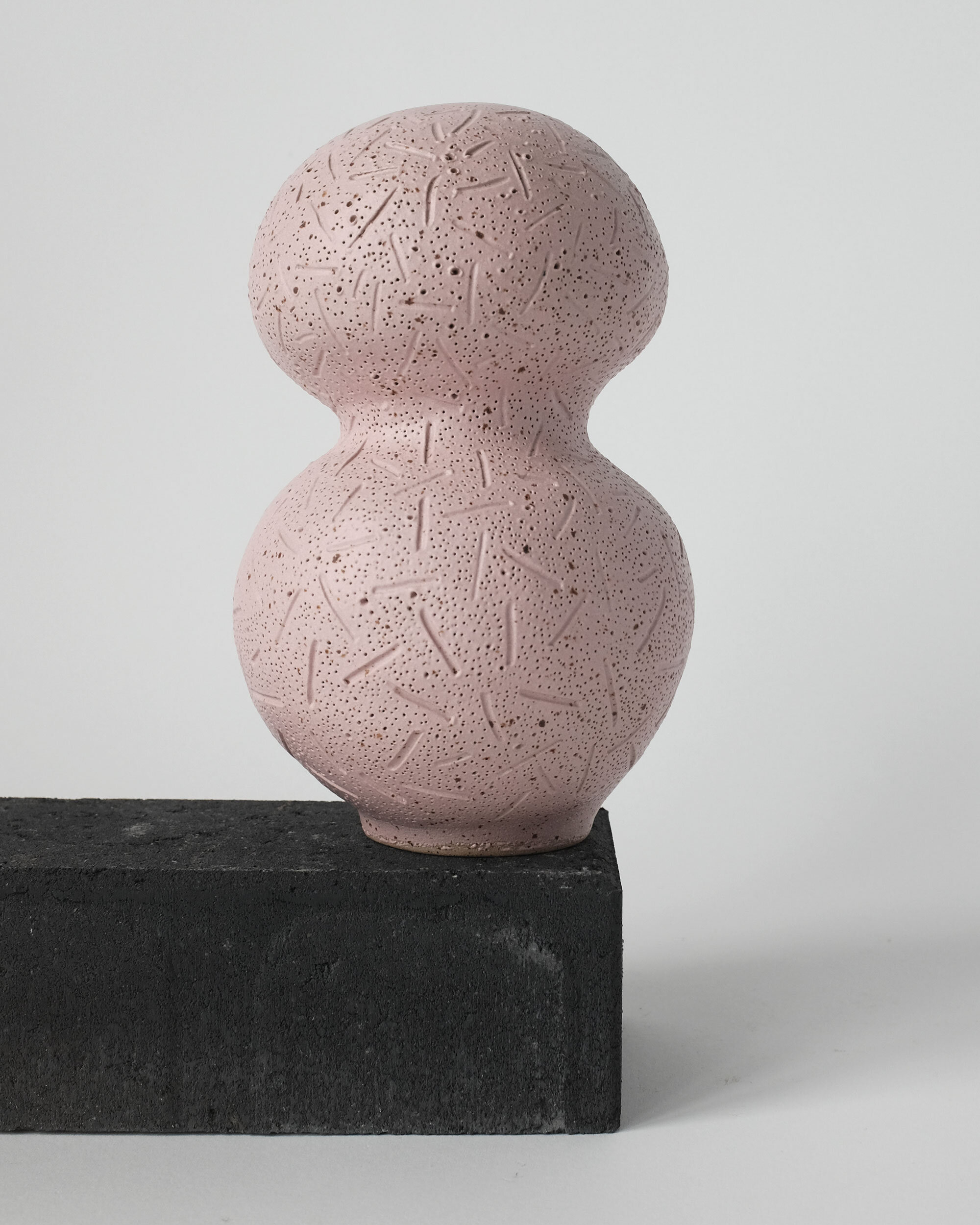 PINK SPECKLED VASE
with sgraffito decoration. approximate measures 14cm diameter and 22cm tall.