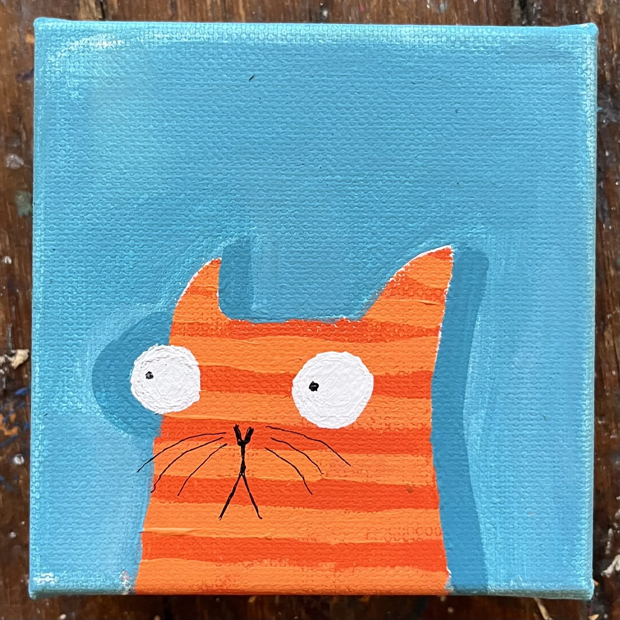 Original 4x4 inch acrylic painting of an orange striped cat named Cheddar with wide white eyes, set against a bright turquoise blue background.