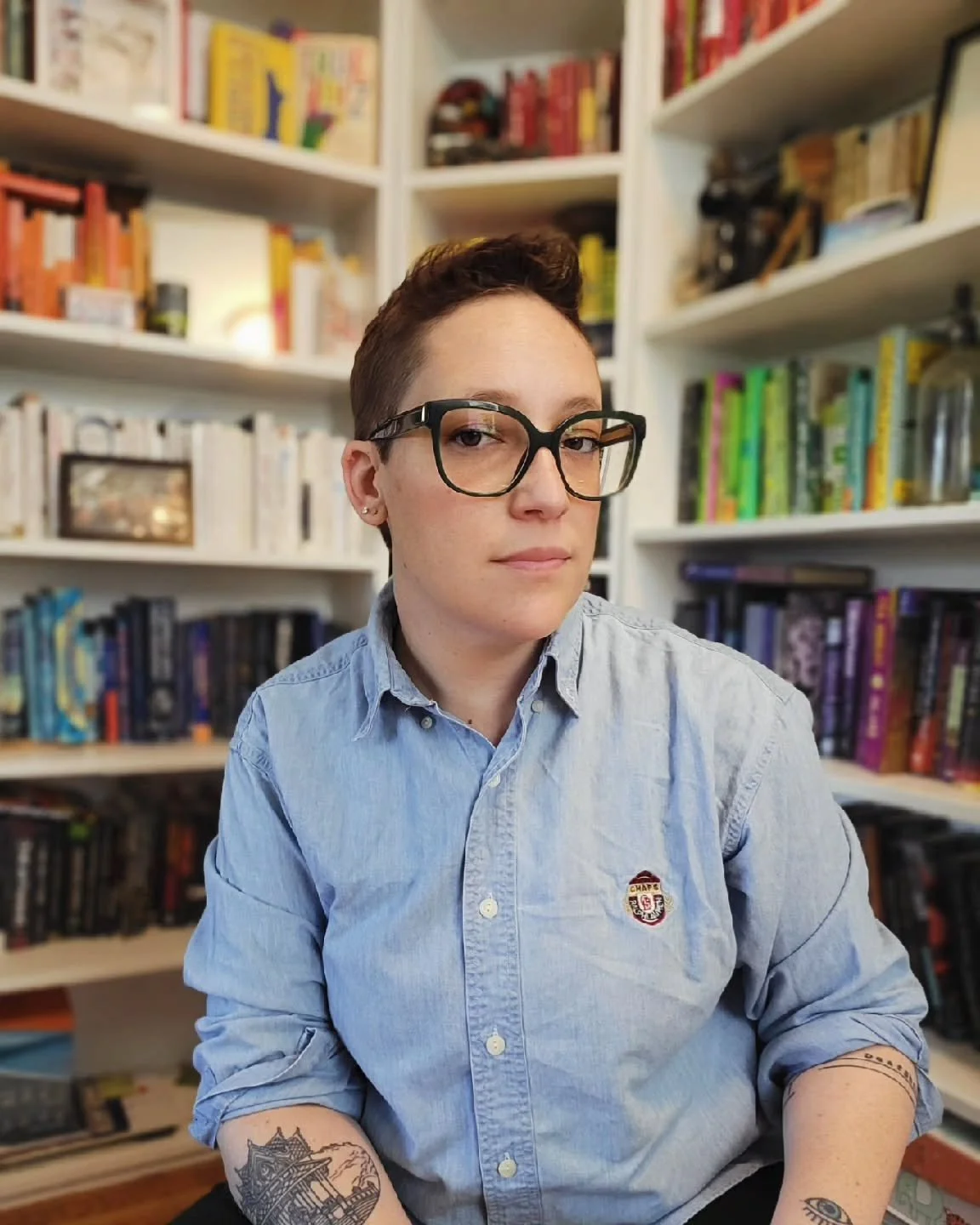 New book, new author photos. Always an exhilarating and embarrassing venture. This isn't the one that ended up on the jacket, but it's definitely my favorite outtake.

ID: Sara is a white person with short brown hair wearing green glasses and a denim