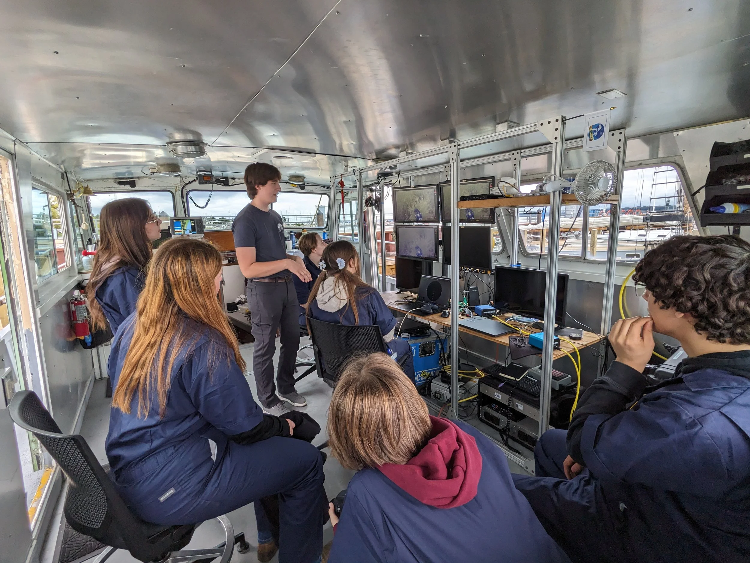 Students watch the camera feed from an underwater ROV