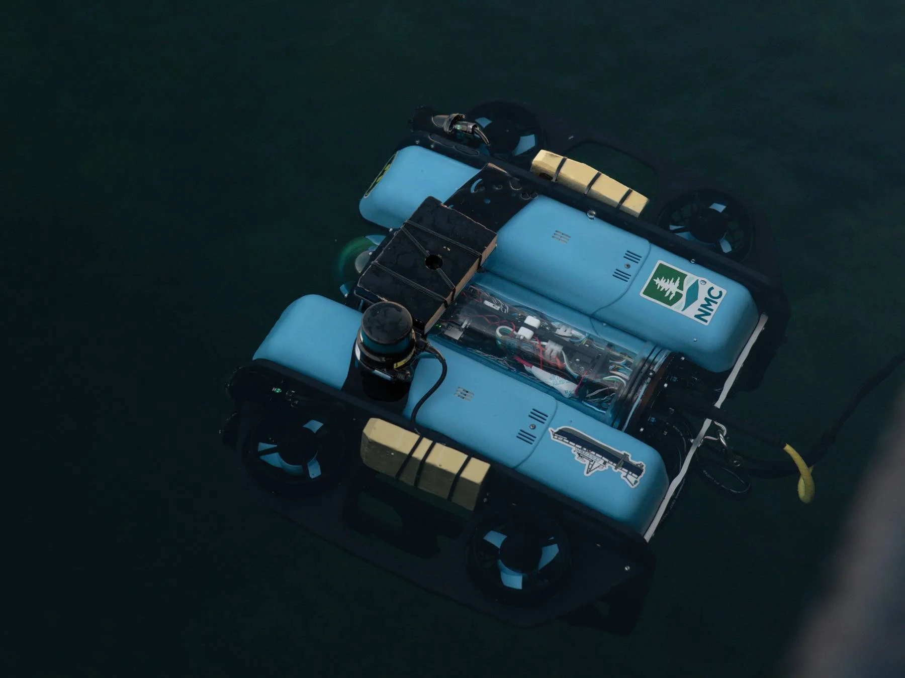 Blue remotely operated underwater vehicle underwater in the bay