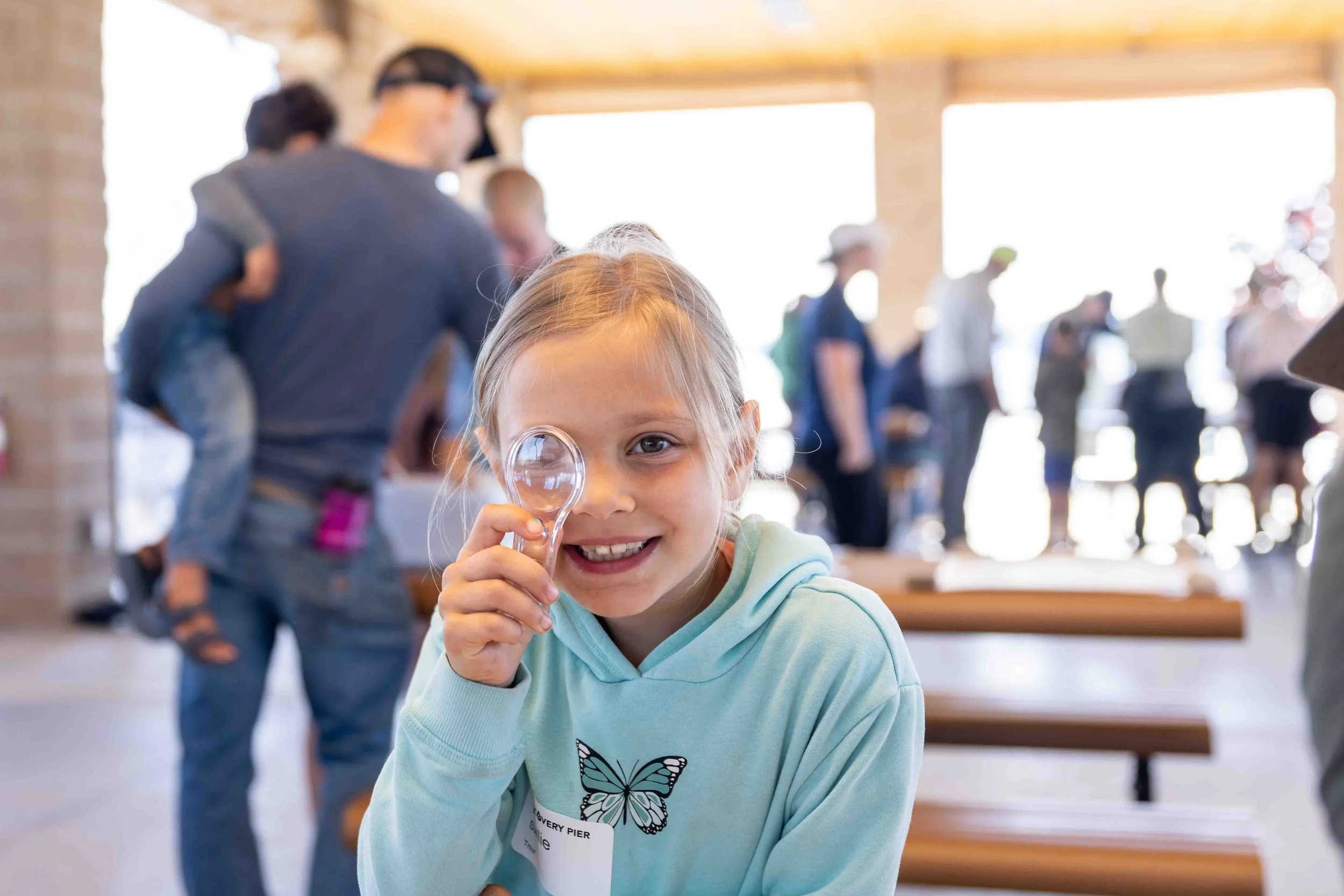 Child looks through magnifying glass