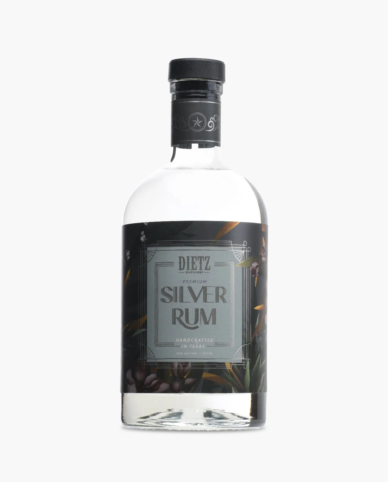 A clear glass bottle of Dietz Distillery Silver Rum with a black cap and decorative label featuring black and purple accents, floral and leaf designs, and text indicating it's handcrafted in Texas.