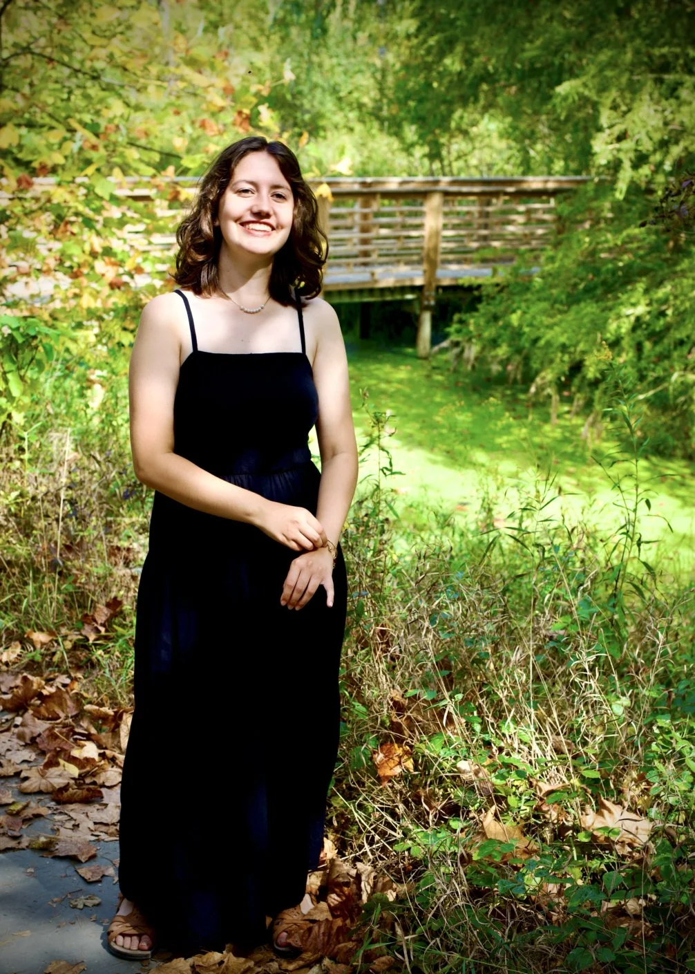 High school senior laughing at golden hour during an Ann Arbor senior photos session at Nichols Arboretum