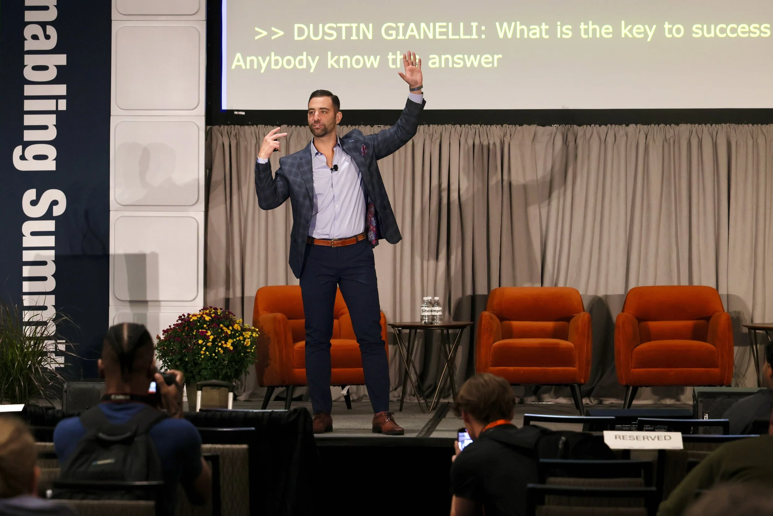 A photo of Dustin on a stage in front of 500+ people (not seen in photo)