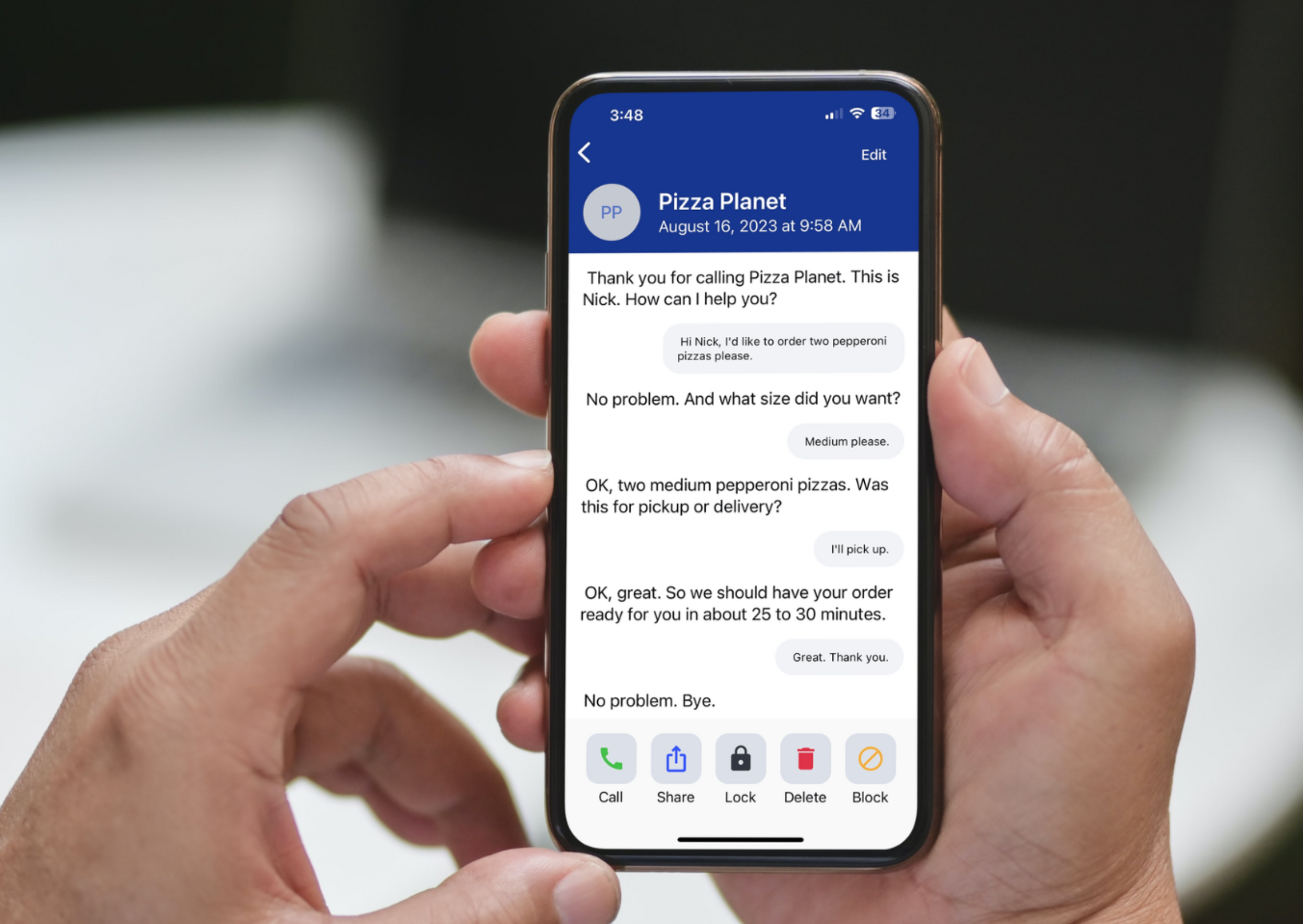 Two hands holding an iPhone showing the InnoCaption interface, a conversation with a pizza restaurant.