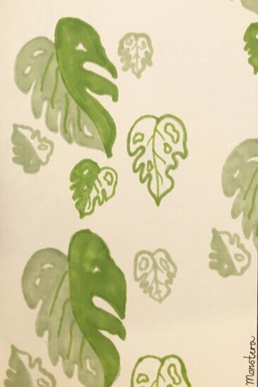 Pattern of green monstera leaves on a white background.