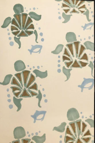 Pattern of stylized turtles and fish in shades of blue and brown on a beige background.
