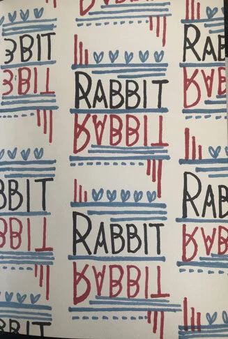 Pattern with the word 'Rabbit' written twice, once in black and once in red, with decorative blue and red lines and hearts.