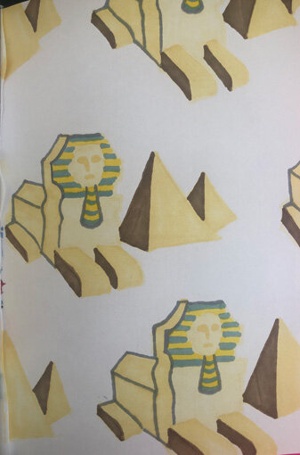 Pattern of Egyptian-themed illustrations including pyramids, sphinxes, and a pharaoh's bust, depicted in beige, brown, and teal colors.