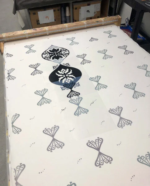 A printing screen with butterfly and floral designs ready for printing on fabric.