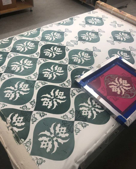 A printing screen with a design of stylized leaves and a repeating plant motif, used for printing fabric or wallpaper.