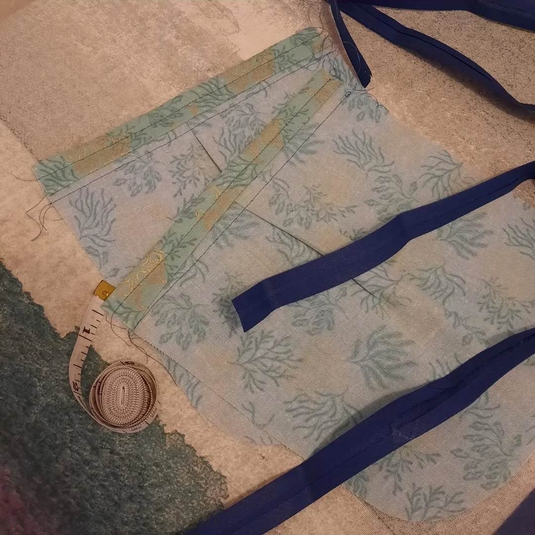 Don't mind me, just working on a new dress, featuring octopus pockets! A few imperfections here and there, but done is better than perfect!

Image Description: Two pieces of fabric are pocket shaped, with the top piece folded and stitched. There are 