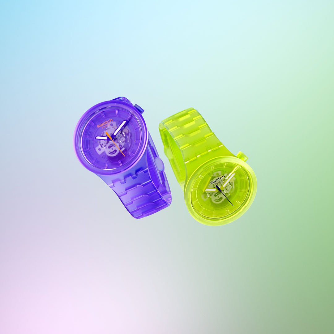 Two colorful wristwatches, one purple and one neon green, with transparent bands, floating against a gradient pastel background.