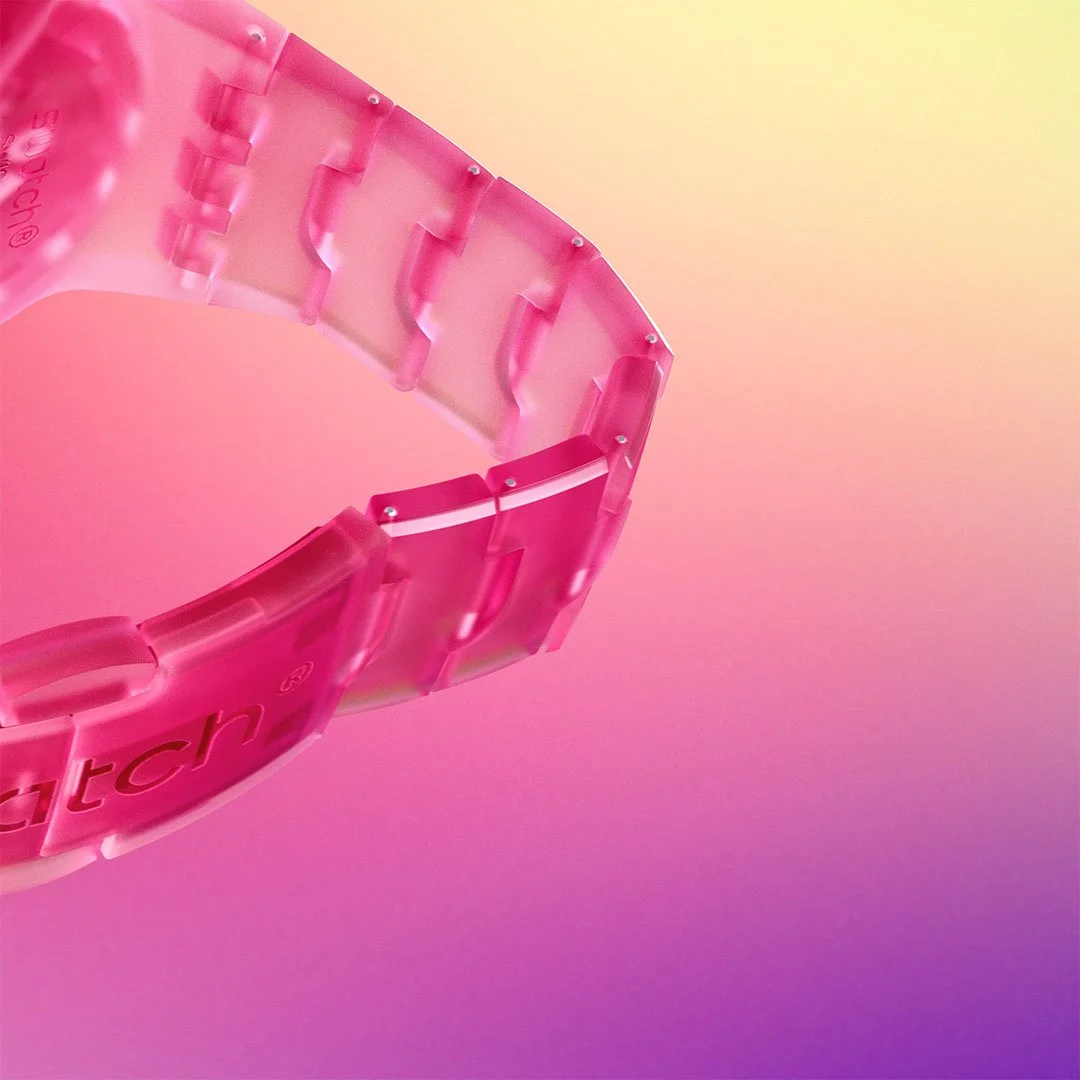Close-up of a pink plastic link bracelet against a gradient pink and yellow background.