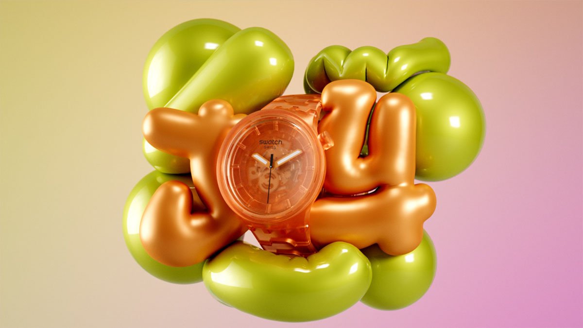 Colorful balloons spelling out 'joy' surrounding an orange transparent watch with a pink watch face.