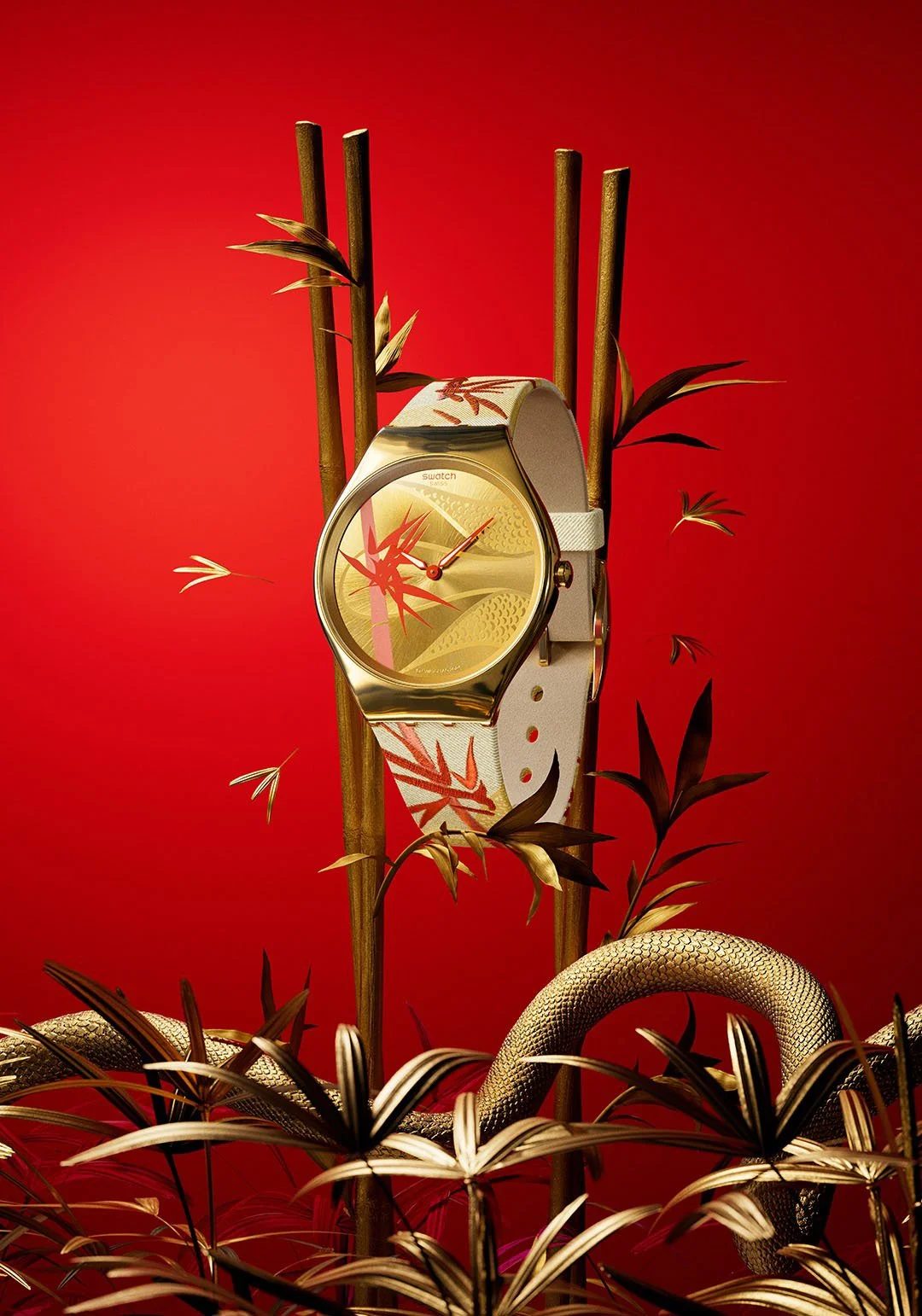 A gold and white wristwatch with a botanical pattern on the strap, displayed against a red background with bamboo and foliage elements, and a coiled snake at the bottom.