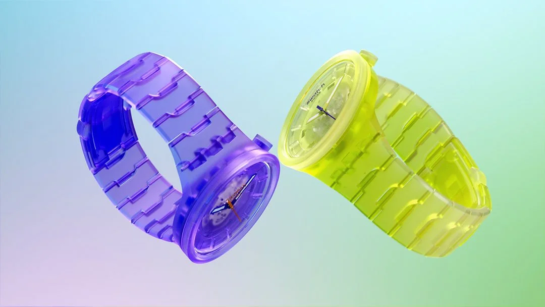 Two translucent plastic watches, one purple and one yellow, with matching bands and round faces, floating against a pastel gradient background.